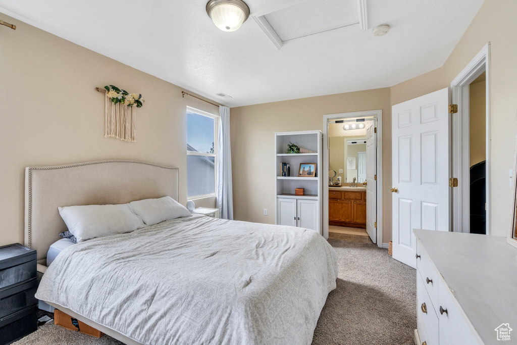 Bedroom with carpet floors, attic access, and connected bathroom