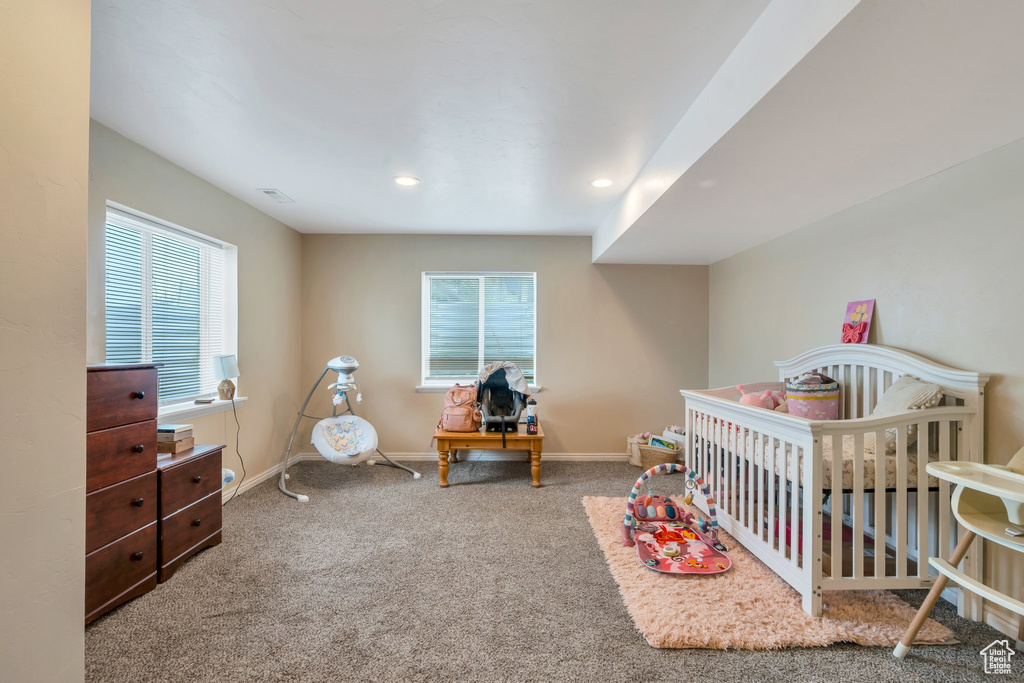 Bedroom with carpet, baseboards, multiple windows, and recessed lighting