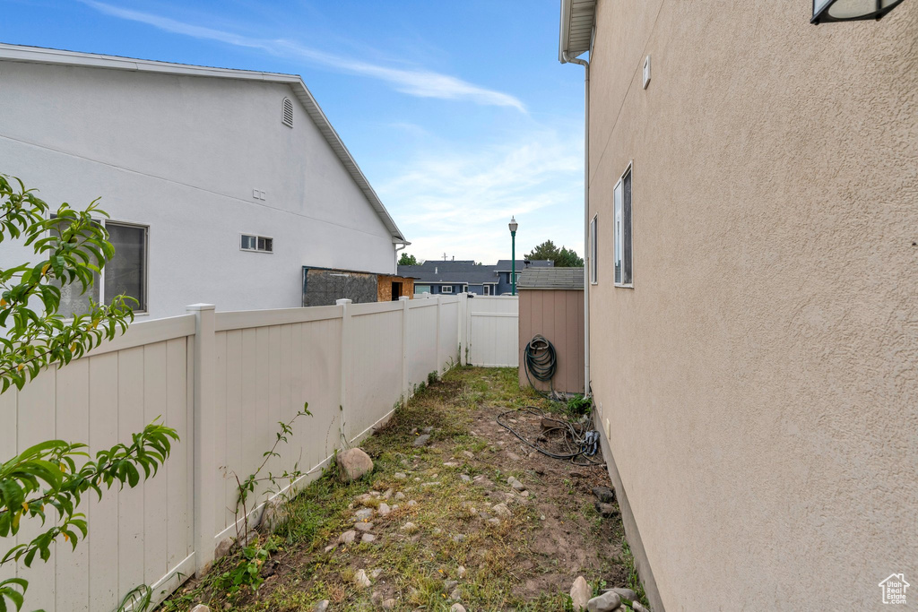 View of property exterior with fence and stucco siding
