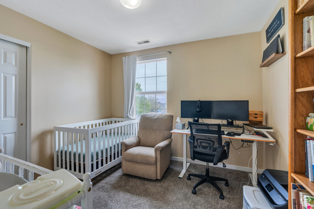 Bedroom featuring carpet flooring, a desk, and baseboards