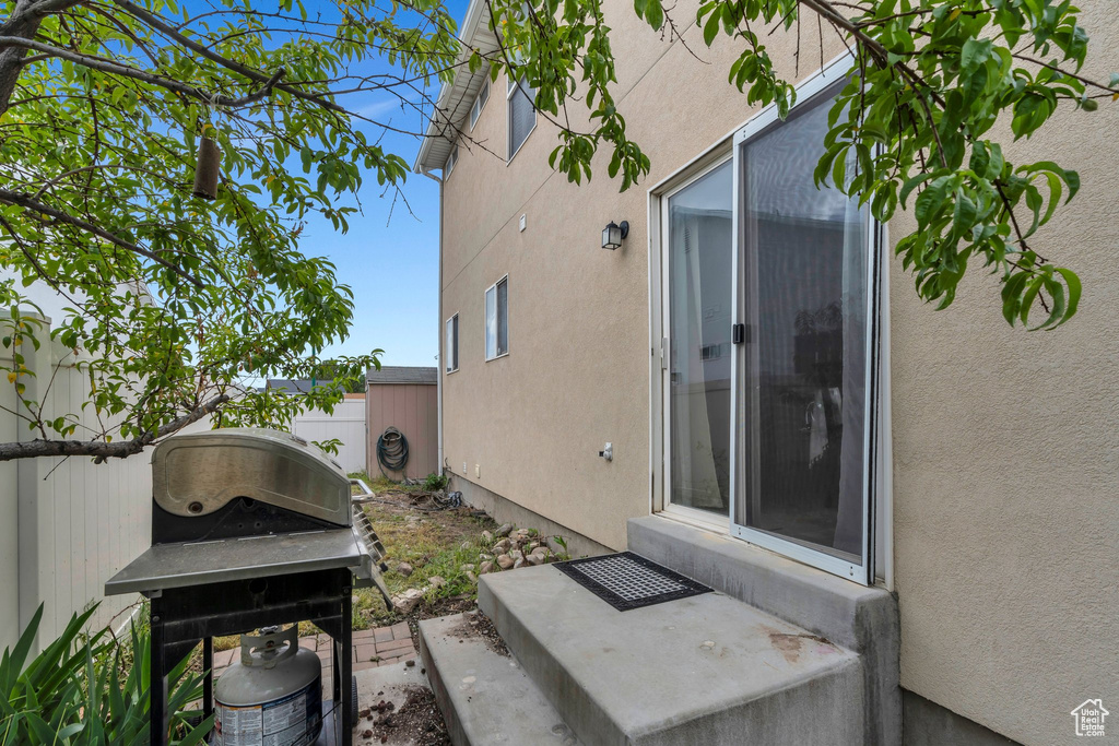 View of property exterior with stucco siding and fence