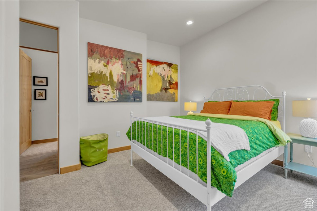 Carpeted bedroom with baseboards and recessed lighting