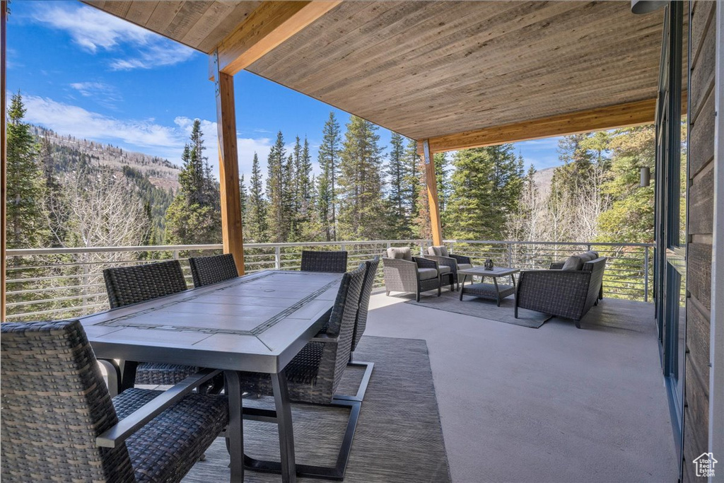 View of patio / terrace featuring an outdoor hangout area, a mountain view, and outdoor dining area