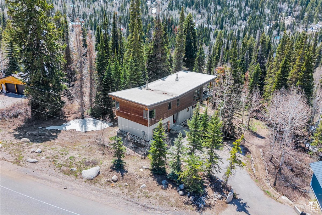 View from above of property with a heavily wooded area