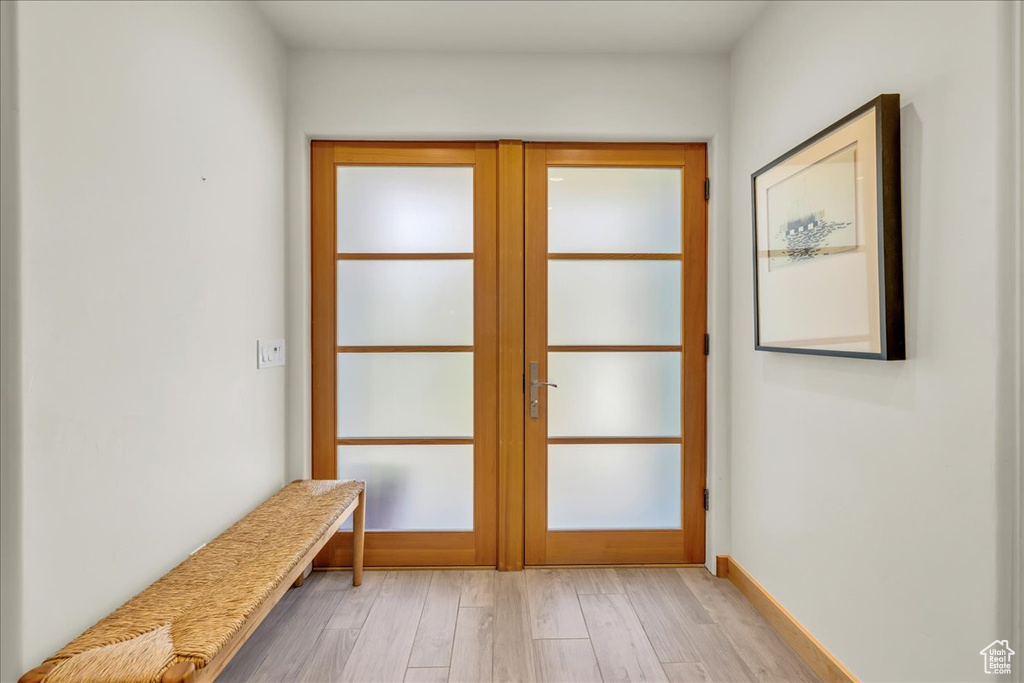 Doorway featuring french doors and light wood-style floors