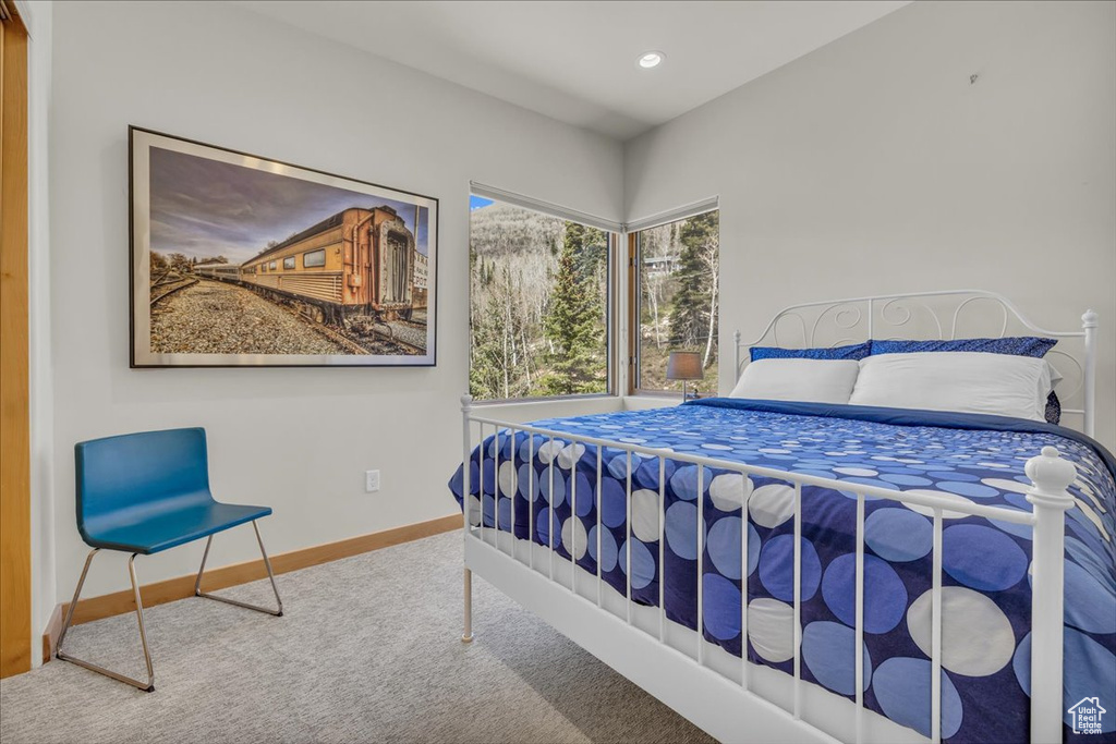 Carpeted bedroom with baseboards and recessed lighting