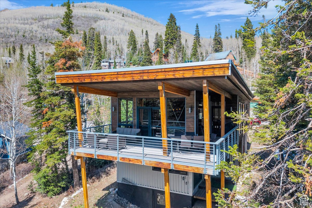 Exterior space featuring a mountain view and a wooded view