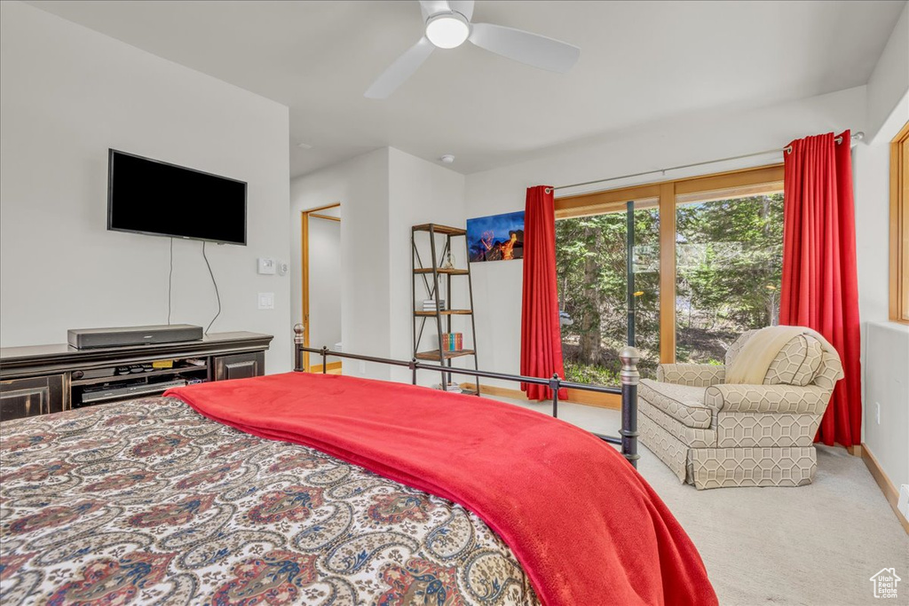 Carpeted bedroom featuring ceiling fan