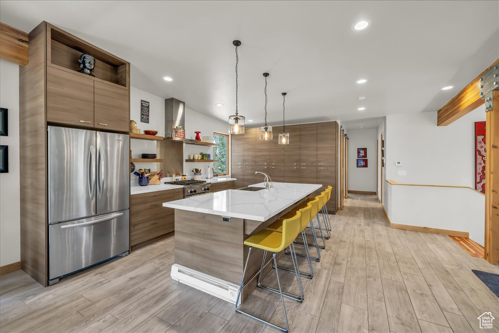 Kitchen with freestanding refrigerator, open shelves, a sink, light wood-style flooring, and recessed lighting