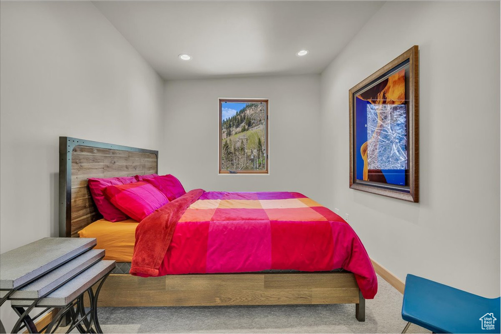 Carpeted bedroom with recessed lighting and baseboards