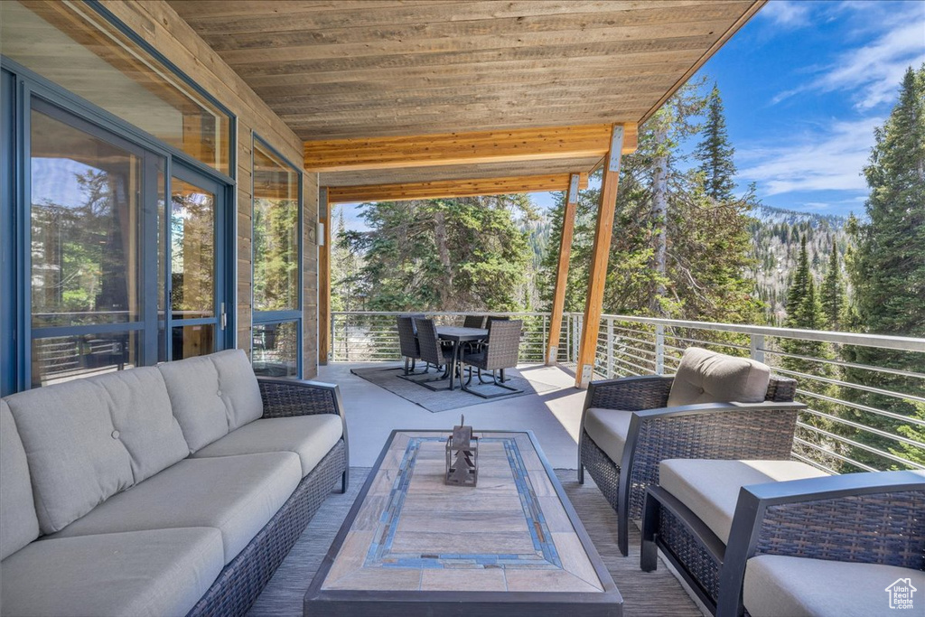 Sunroom with an outdoor living space, plenty of natural light, and outdoor dining area