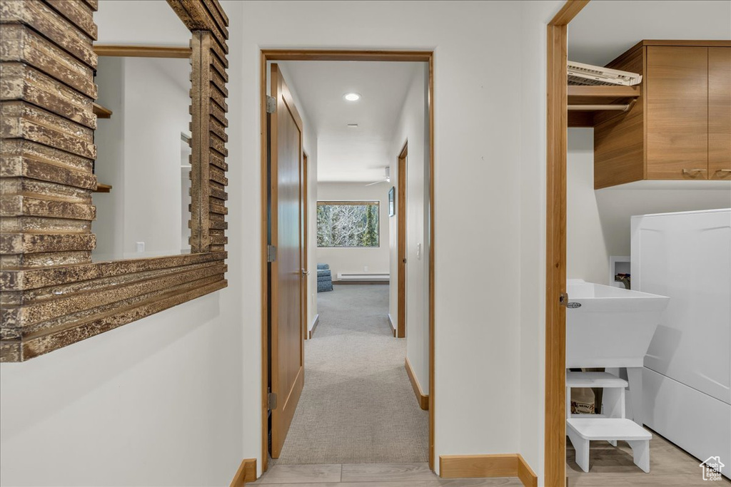 Hallway featuring recessed lighting and baseboards