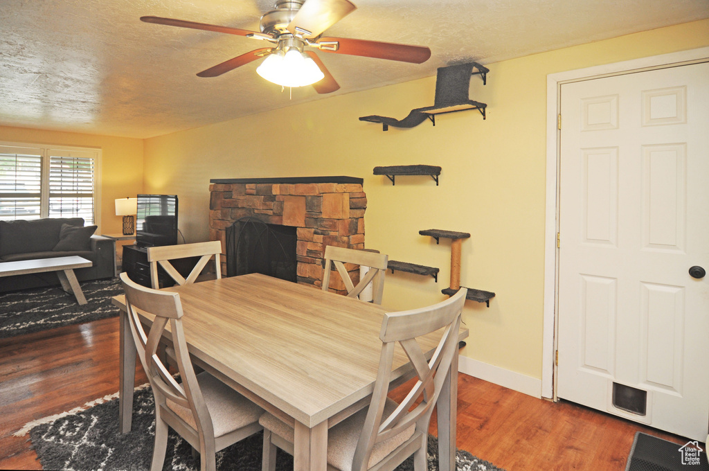 Dining room featuring wood finished floors, ceiling fan, and baseboards