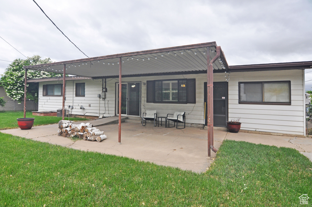 Back of property featuring a yard and a patio