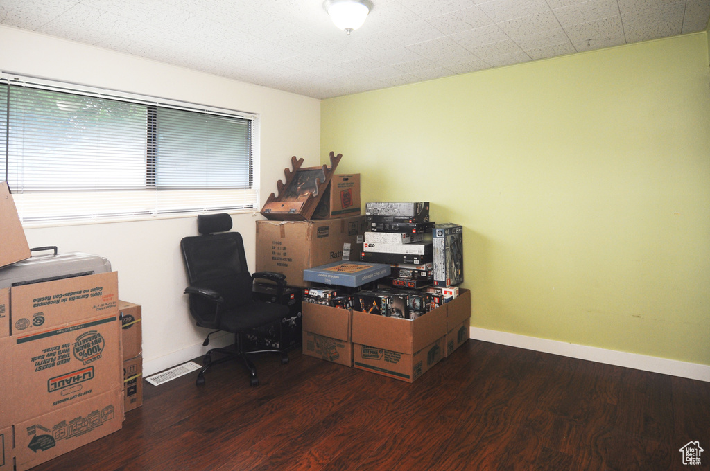 Home office featuring wood finished floors and baseboards