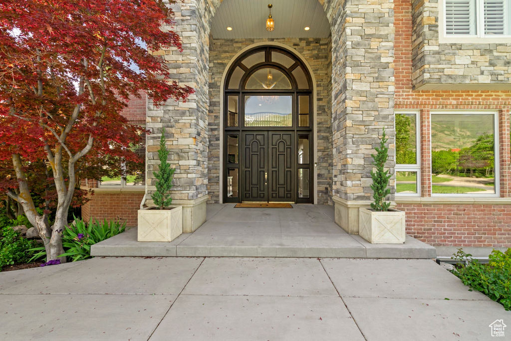 Doorway to property with brick siding and stone siding