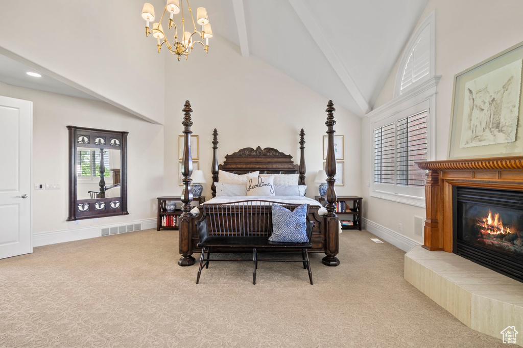 Bedroom featuring light colored carpet, multiple windows, a glass covered fireplace, high vaulted ceiling, and beam ceiling