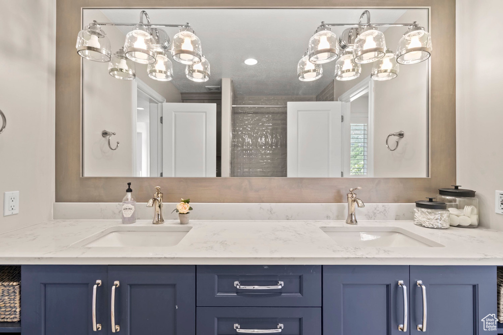 Bathroom with a chandelier and double vanity