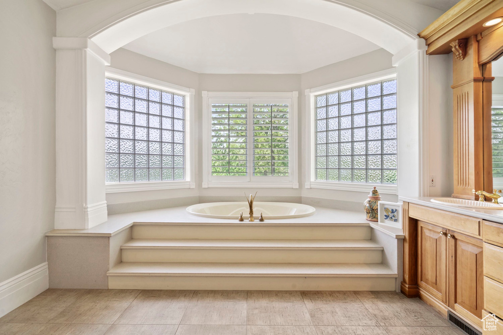 Full bath featuring vanity and a garden tub