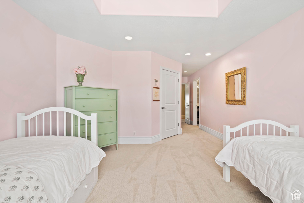 Bedroom featuring light colored carpet, recessed lighting, baseboards, and a skylight