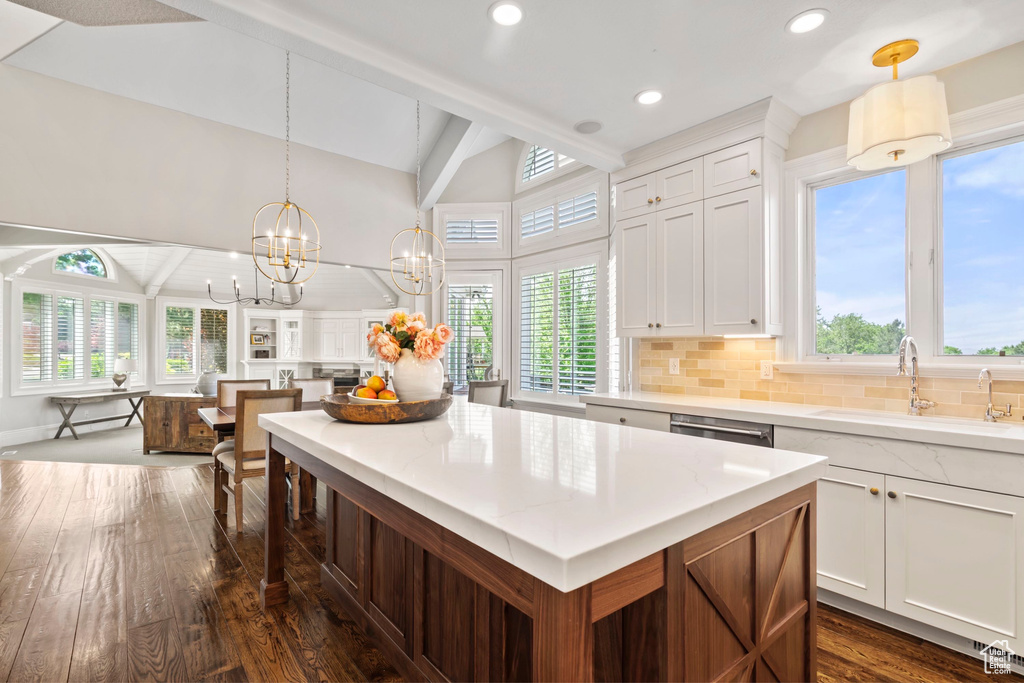 Kitchen with a sink, healthy amount of natural light, dark wood-type flooring, and recessed lighting