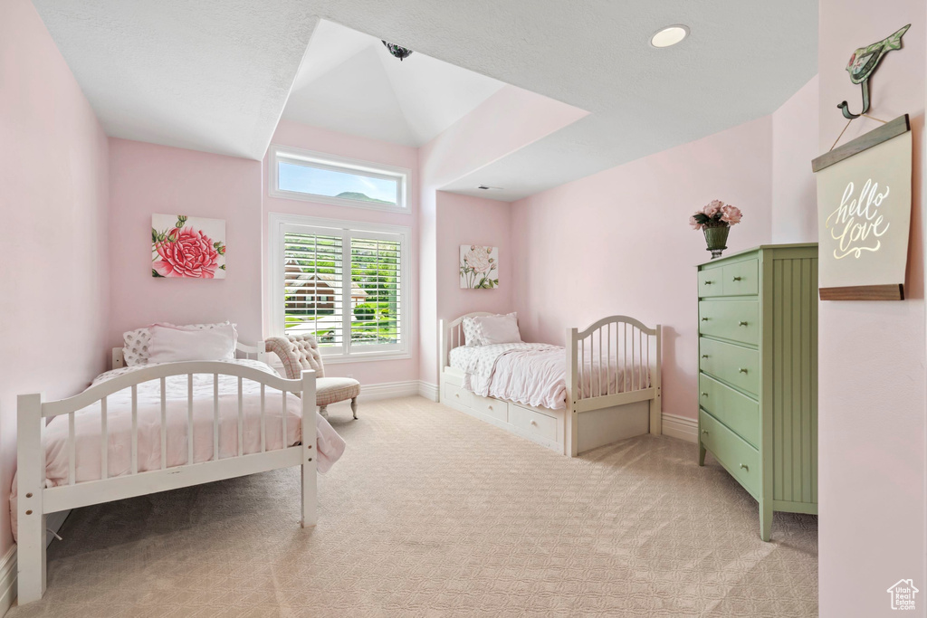 Bedroom featuring light carpet and baseboards