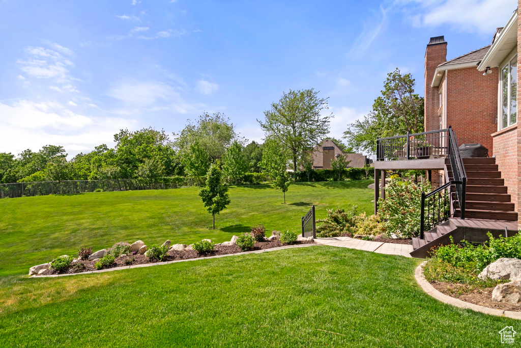 View of yard with stairs and a deck