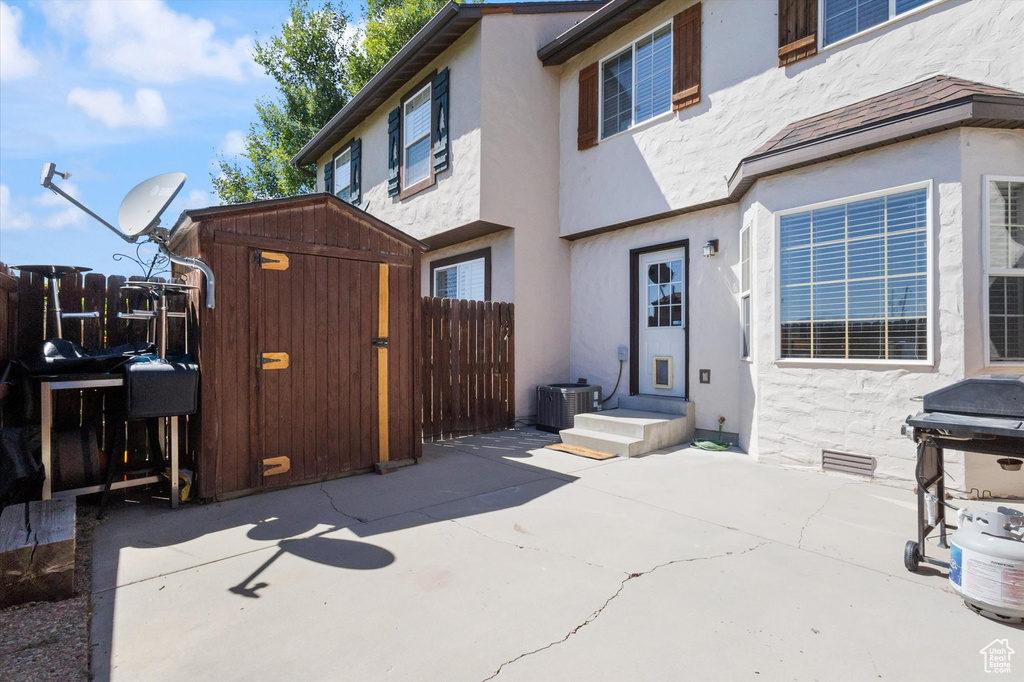Back of house with a patio, stucco siding, and entry steps