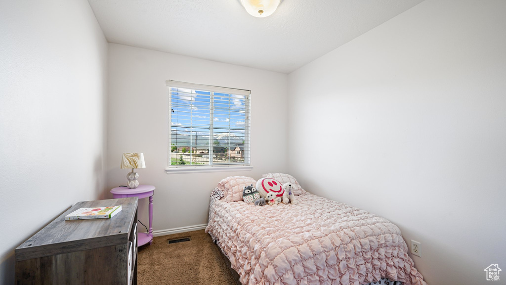 Carpeted bedroom featuring baseboards