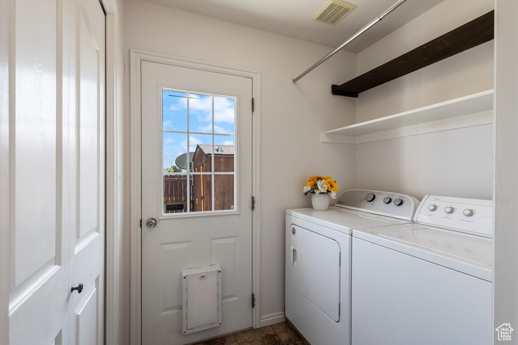 Washroom featuring washing machine and dryer