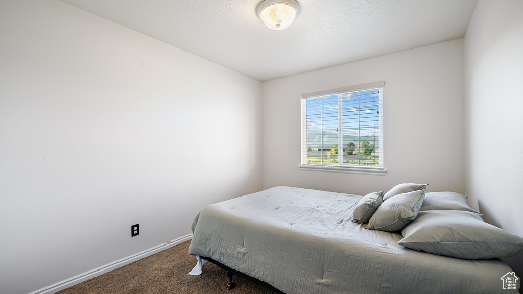 Carpeted bedroom featuring baseboards