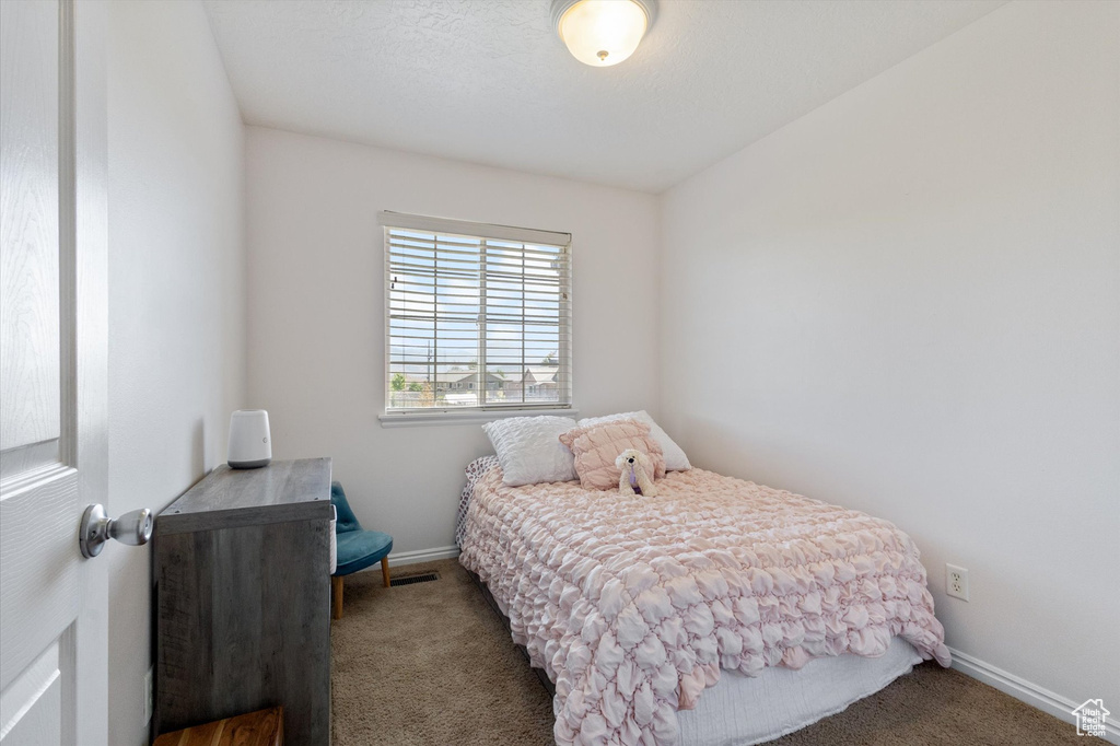 Carpeted bedroom featuring baseboards