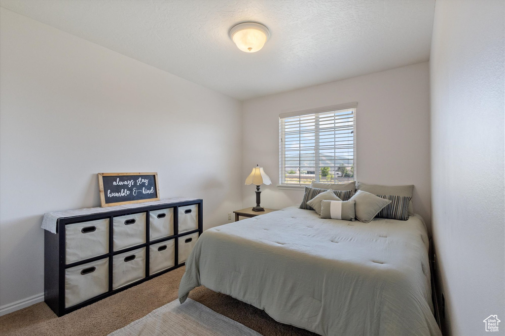 Carpeted bedroom featuring baseboards