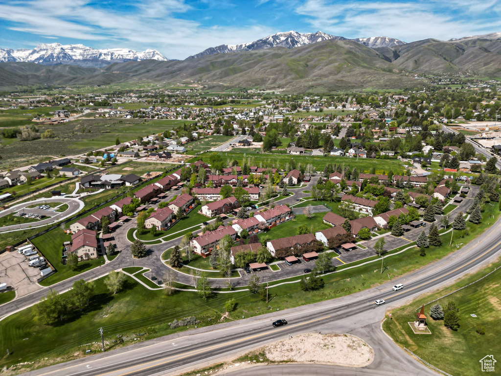 Aerial view of property's location featuring a mountainous background and nearby suburban area