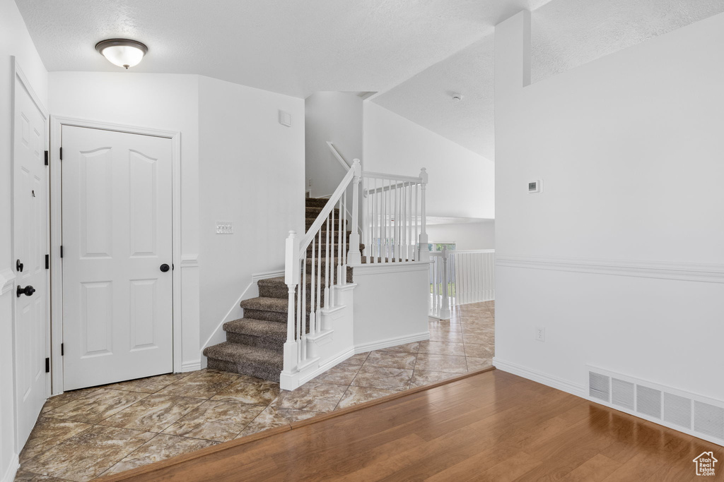 Stairs featuring wood finished floors and baseboards