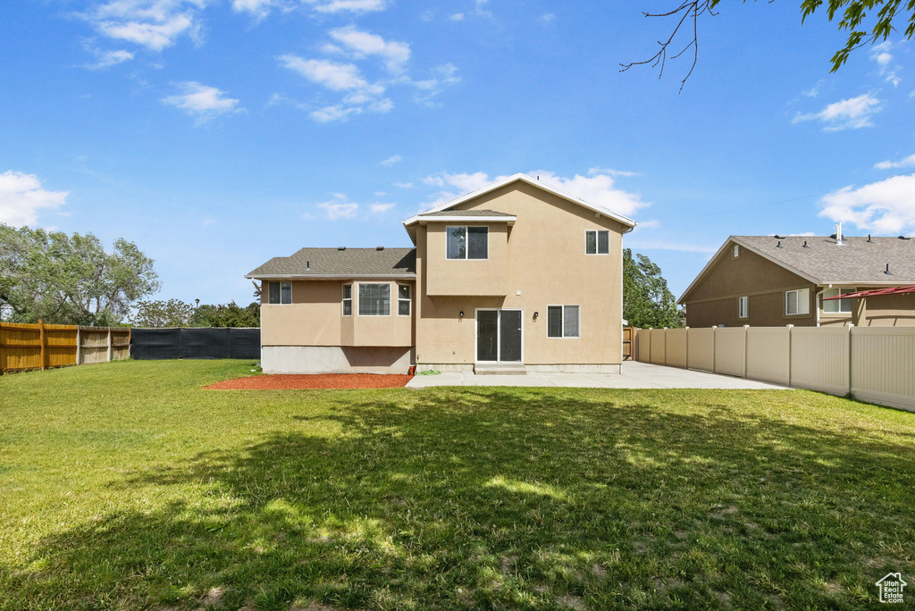 Rear view of property featuring a patio area and stucco siding