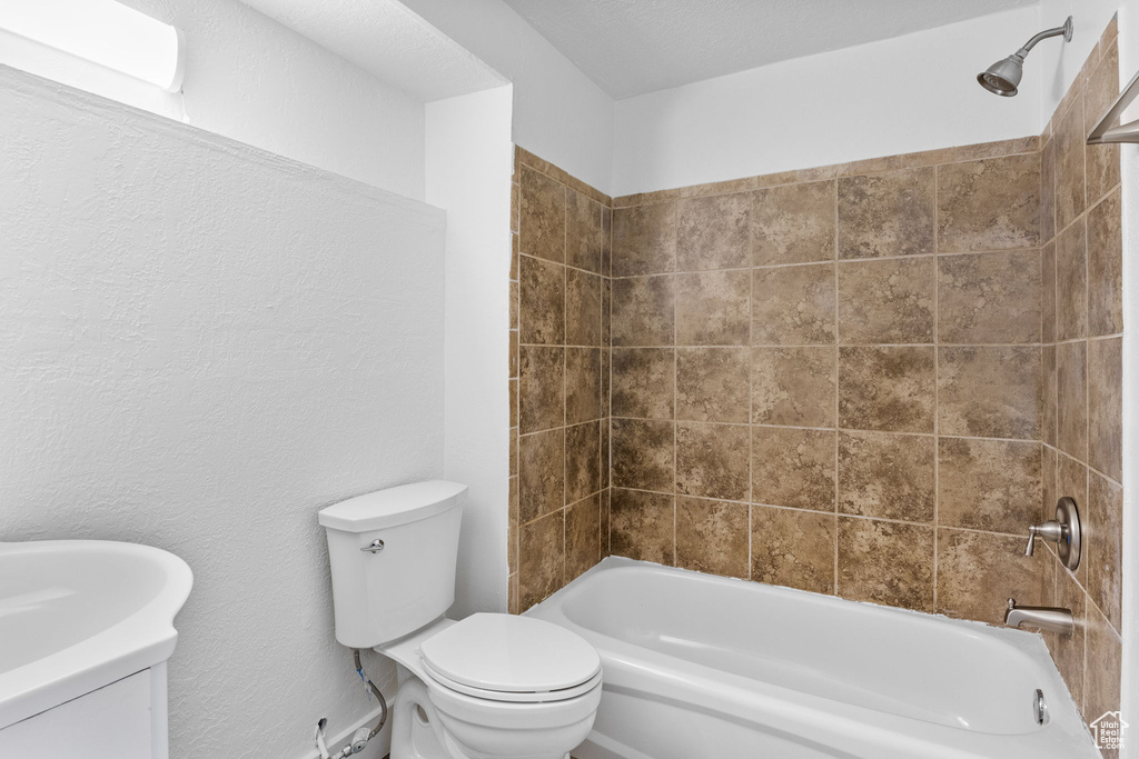 Bathroom with toilet, tub / shower combination, and vanity