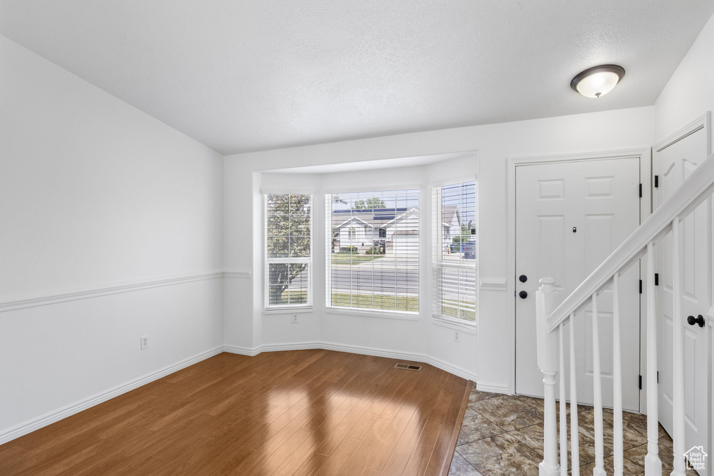 Foyer with wood finished floors and baseboards