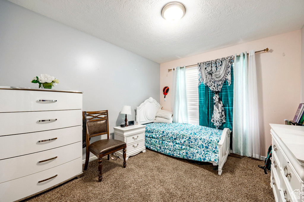 Carpeted bedroom with a textured ceiling