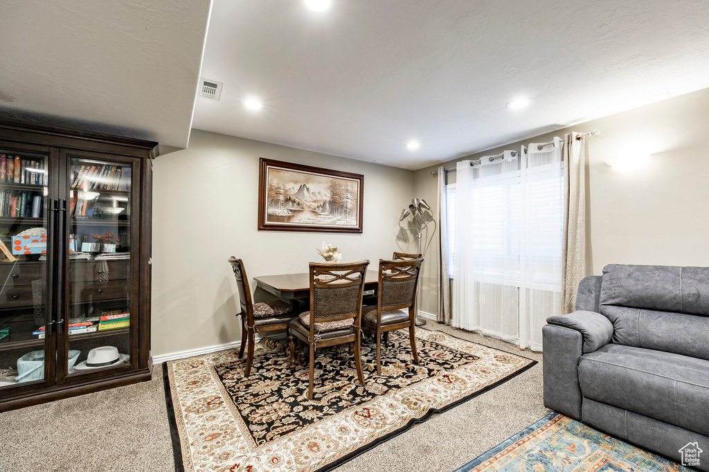 Carpeted dining space featuring baseboards, recessed lighting, and visible vents