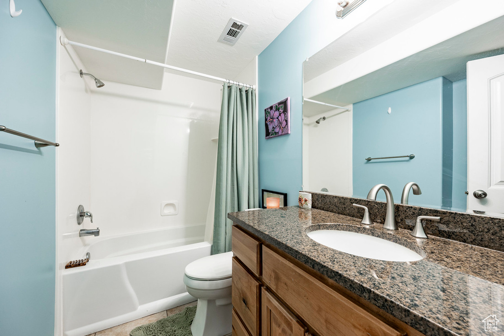 Bathroom with shower / bath combo with shower curtain, toilet, visible vents, tile patterned flooring, and vanity