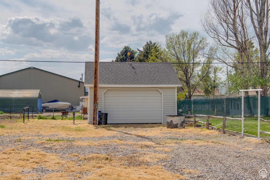 Detached garage featuring fence