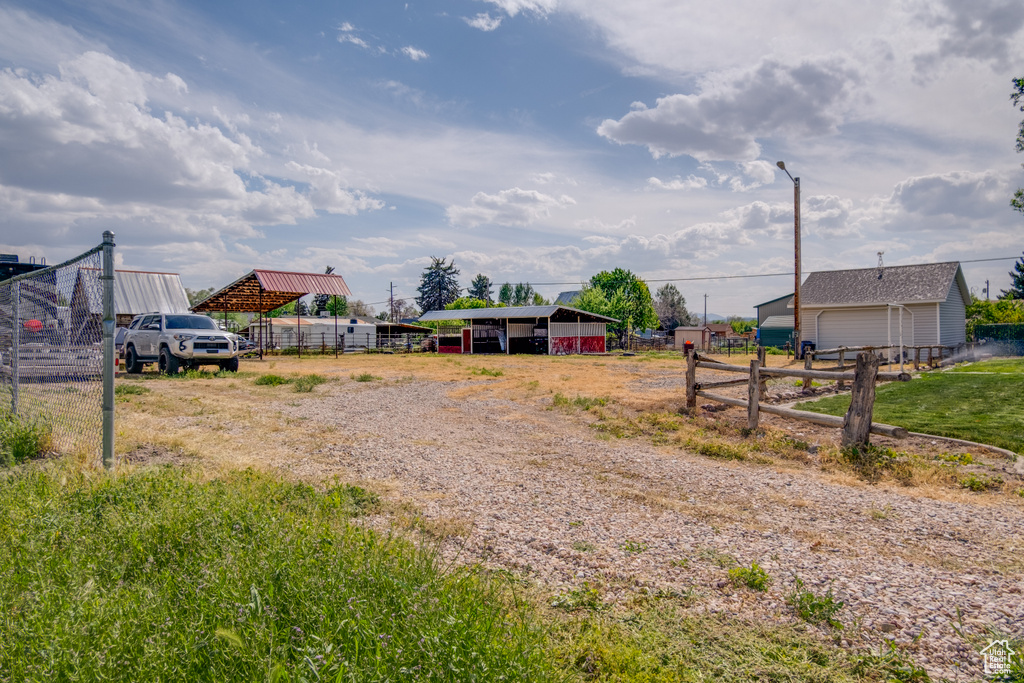 View of dirt / gravel road featuring street lighting
