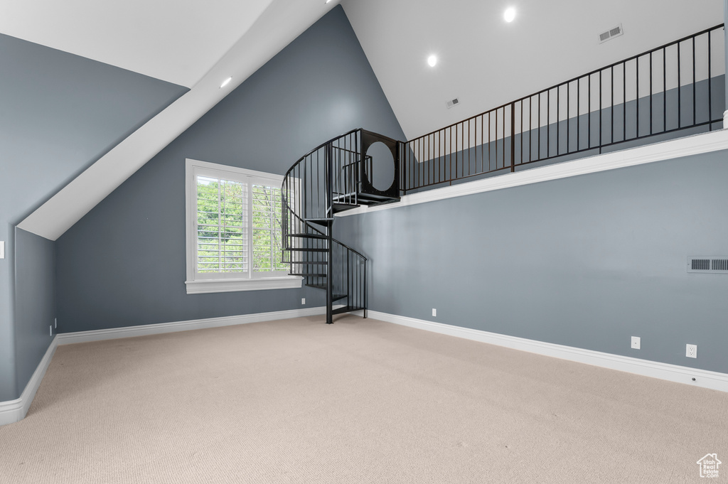 Staircase with carpet, baseboards, high vaulted ceiling, and recessed lighting