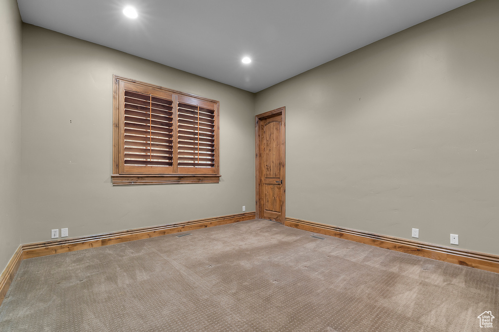 Spare room with carpet floors, baseboards, and recessed lighting