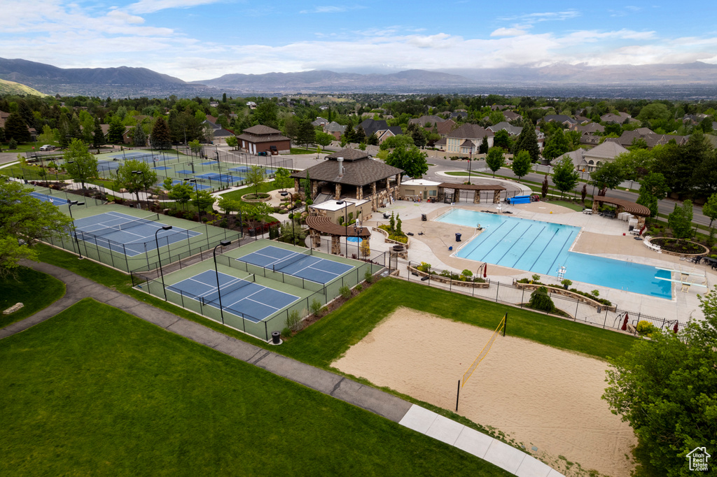 Aerial perspective of suburban area featuring a pool area and mountains