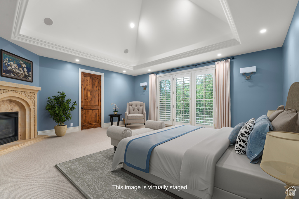 Bedroom with a tray ceiling, carpet floors, recessed lighting, and a high end fireplace