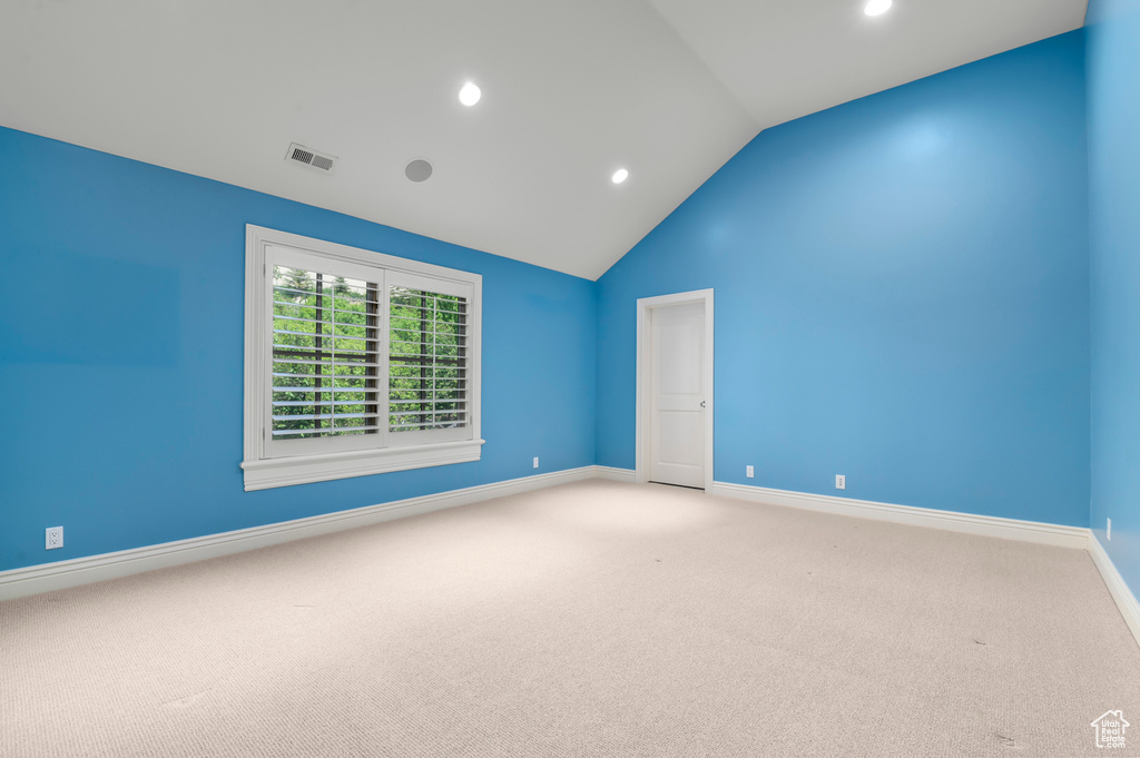 Carpeted spare room with lofted ceiling, recessed lighting, and baseboards