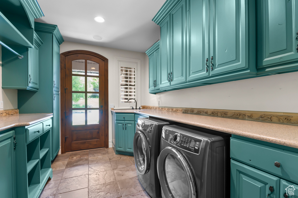 Laundry room featuring washing machine and clothes dryer, cabinet space, and recessed lighting