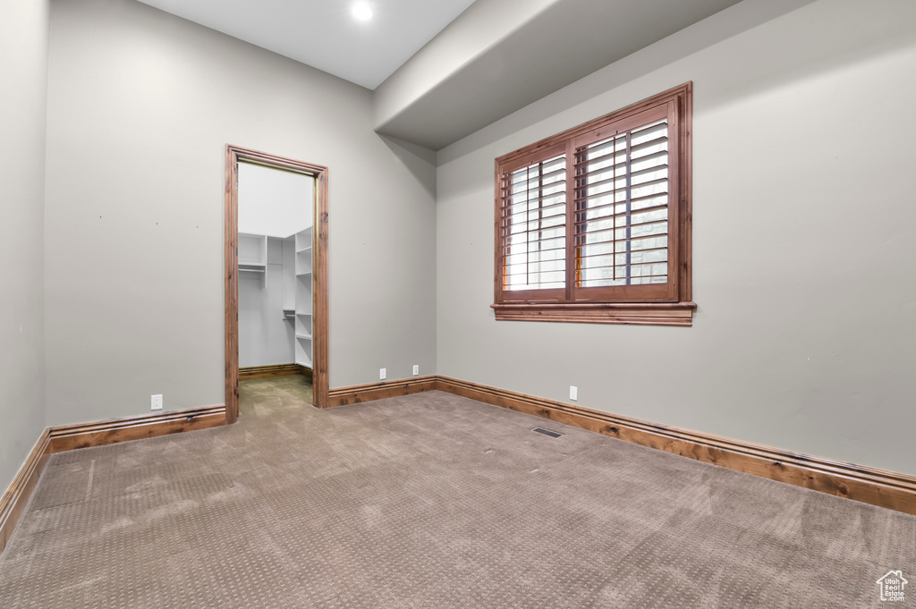 Unfurnished room featuring carpet flooring and baseboards